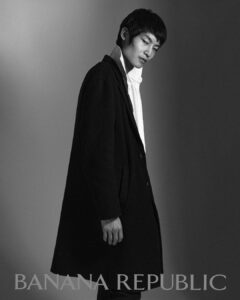 Woojin Ham in a black coat and white shirt, monochrome